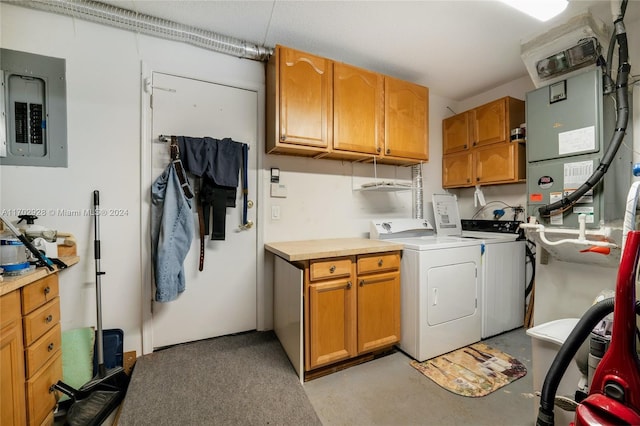 laundry room featuring electric panel, separate washer and dryer, and cabinets