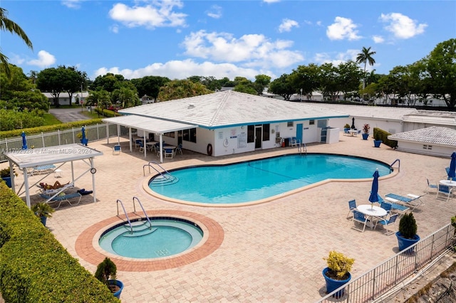 view of swimming pool with a patio and a hot tub