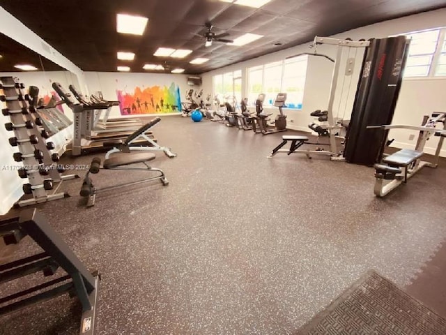 exercise room with ceiling fan