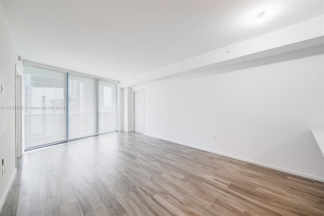 unfurnished room with light wood-type flooring