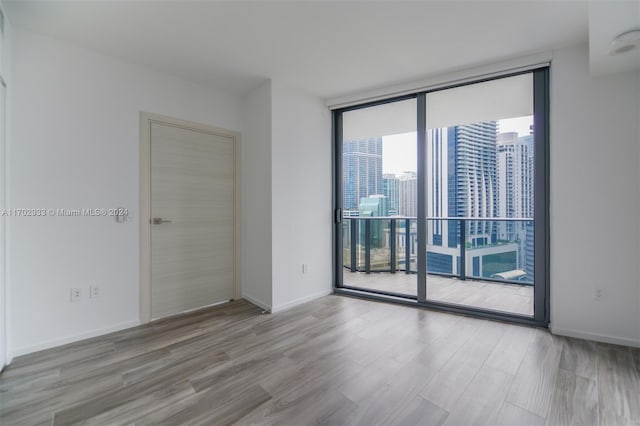 unfurnished room with light wood-type flooring