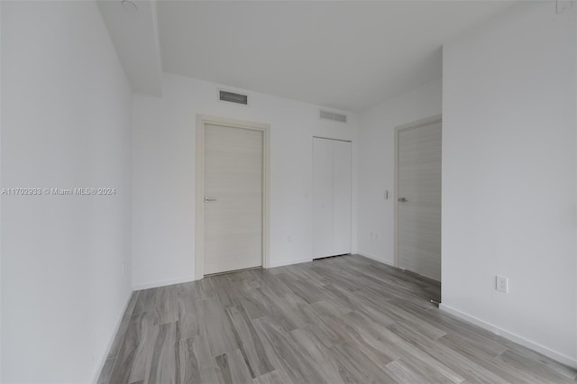 empty room with light hardwood / wood-style flooring