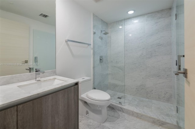 bathroom with an enclosed shower, vanity, and toilet