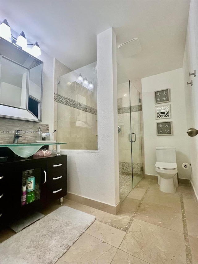 bathroom with vanity, toilet, and a shower with shower door