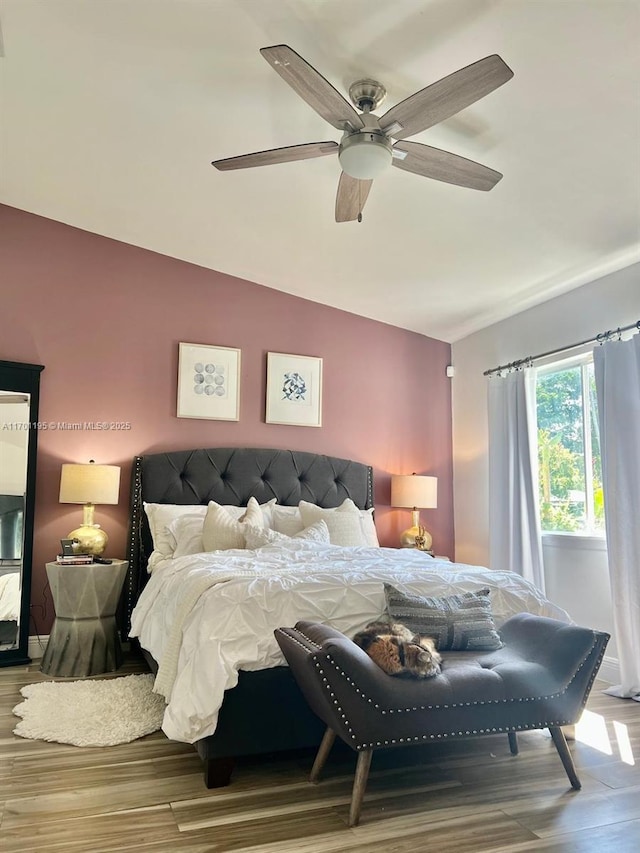 bedroom featuring wood-type flooring, ceiling fan, and lofted ceiling