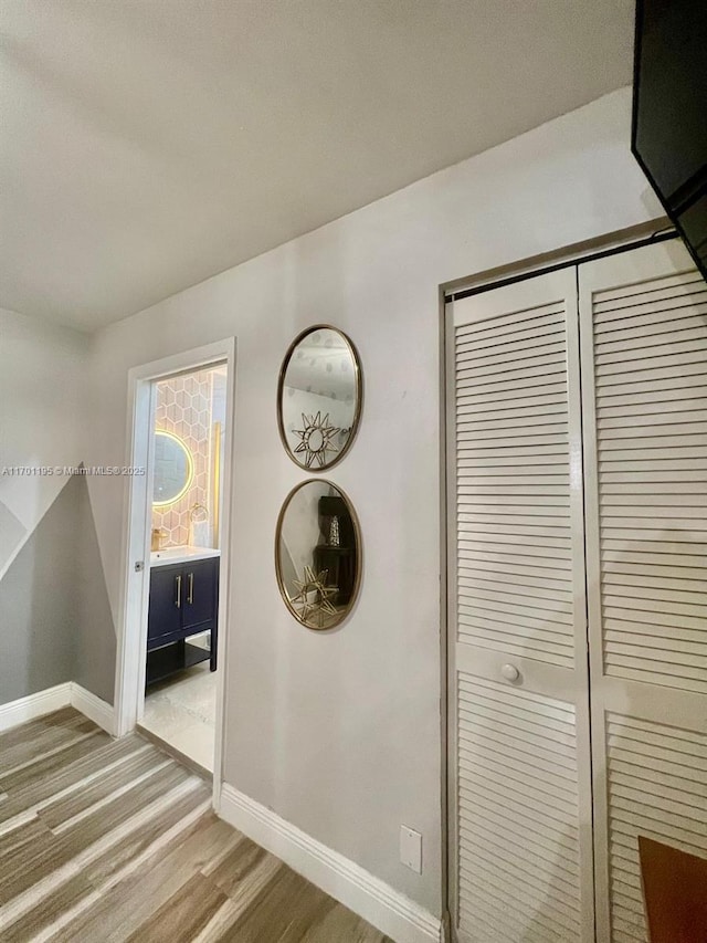 corridor with hardwood / wood-style flooring