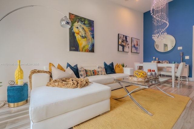 living room with wood-type flooring and an inviting chandelier