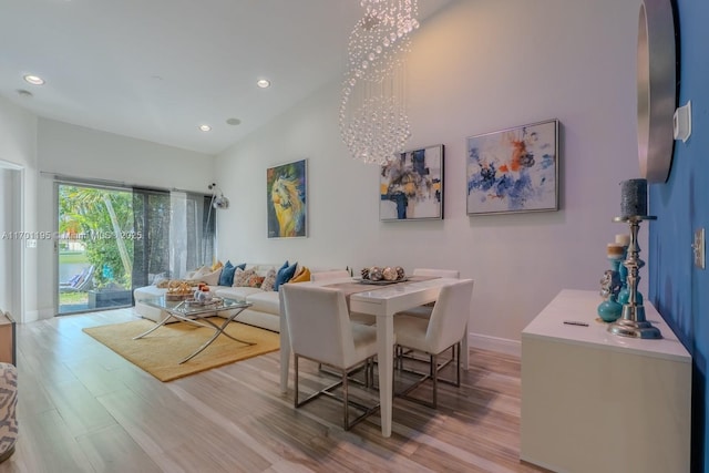 dining space featuring a chandelier and light wood-type flooring