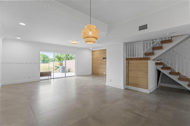 unfurnished room featuring concrete flooring and crown molding