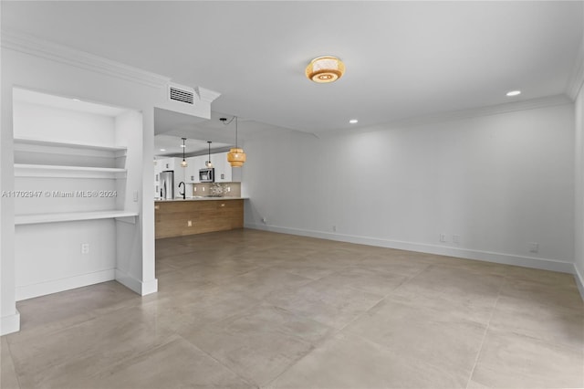 unfurnished living room with crown molding and sink