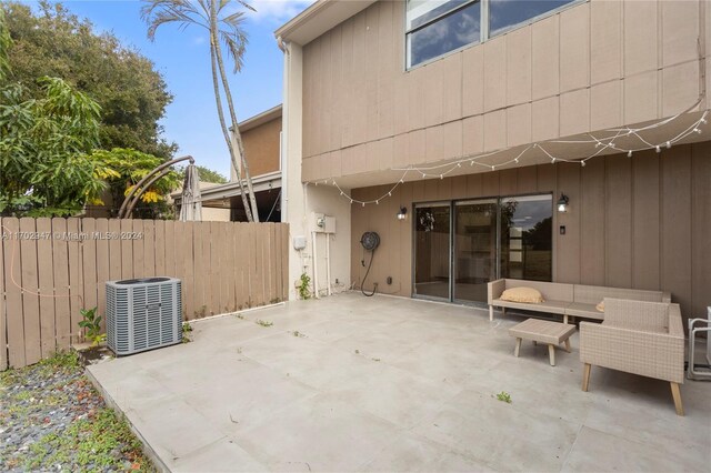 rear view of property featuring a patio area and cooling unit