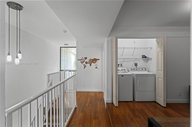 washroom featuring crown molding, independent washer and dryer, and dark wood-type flooring