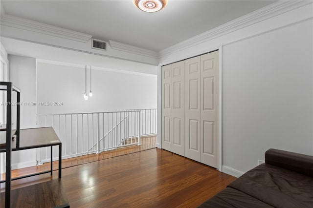 sitting room featuring dark hardwood / wood-style flooring and ornamental molding