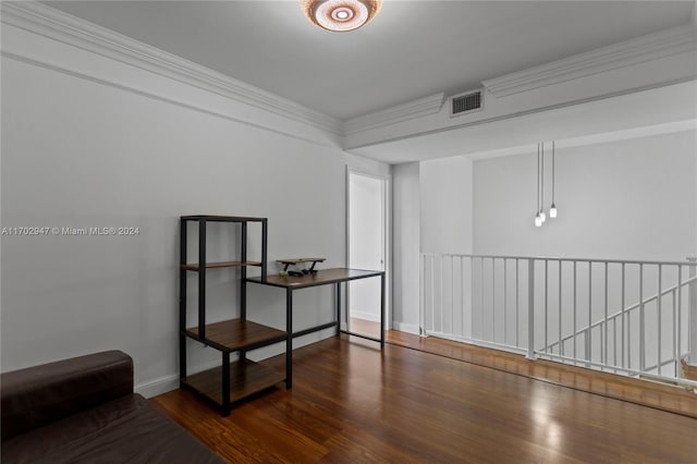 empty room featuring crown molding and dark wood-type flooring