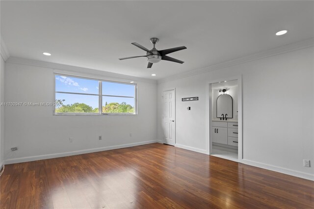 empty room featuring dark hardwood / wood-style floors, ceiling fan, and crown molding