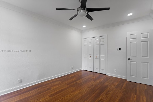 unfurnished bedroom featuring a closet, ceiling fan, dark hardwood / wood-style flooring, and ornamental molding