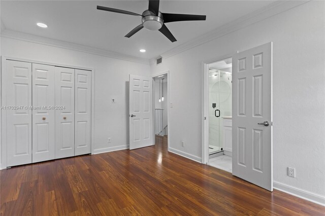 unfurnished bedroom with ensuite bath, ceiling fan, crown molding, and dark wood-type flooring