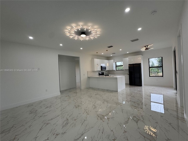 unfurnished living room featuring sink