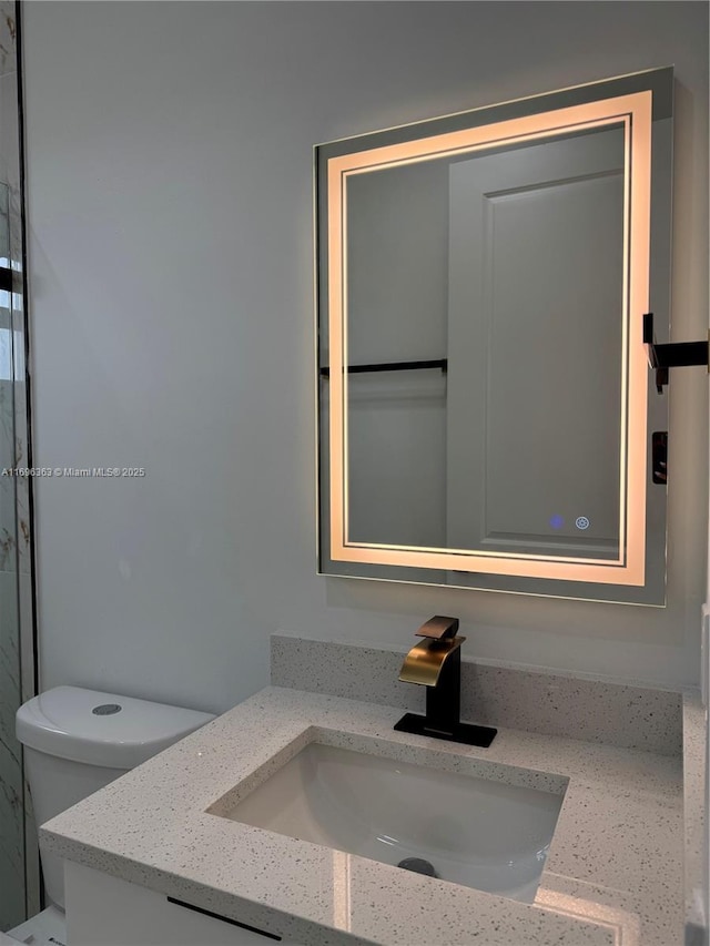 bathroom featuring vanity and toilet