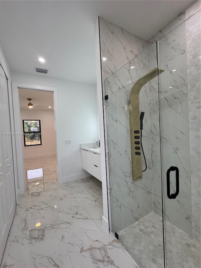 bathroom featuring vanity and a shower with door