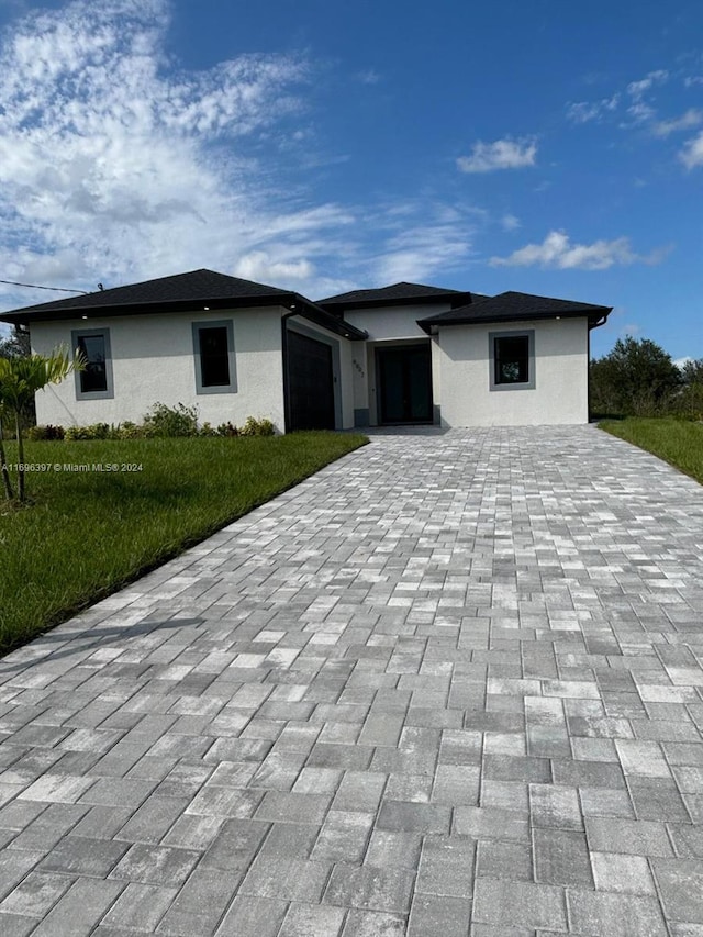 view of front facade with a front lawn and a garage