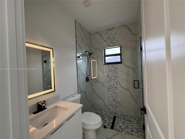 bathroom featuring vanity, an enclosed shower, and toilet