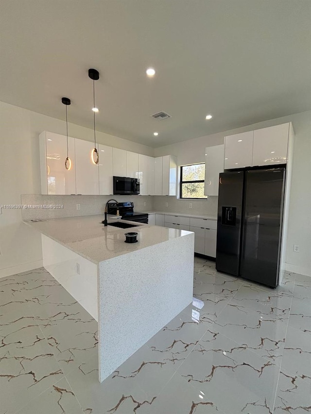 kitchen with black appliances, decorative light fixtures, white cabinetry, and kitchen peninsula