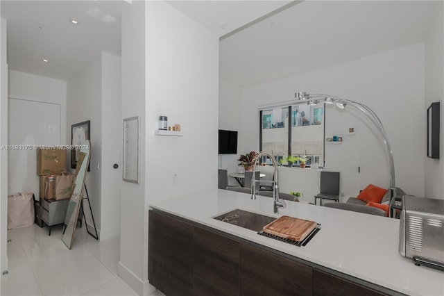 301 Altara Ave Unit 305, Coral Gables, FL 33146 - kitchen featuring modern cabinets, light countertops, light tile patterned floors, and dark brown cabinetry