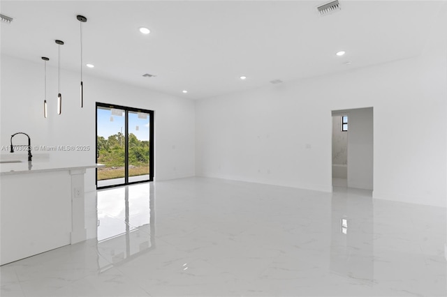 empty room with marble finish floor, a sink, visible vents, and recessed lighting