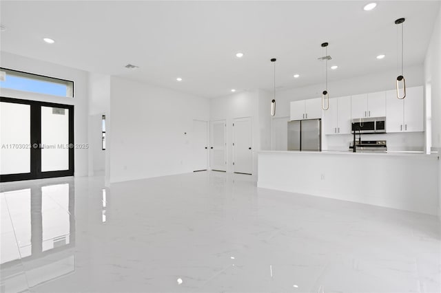 unfurnished living room with marble finish floor, recessed lighting, visible vents, and french doors