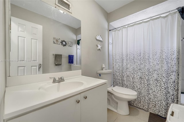 bathroom with tile patterned flooring, vanity, toilet, and a shower with curtain