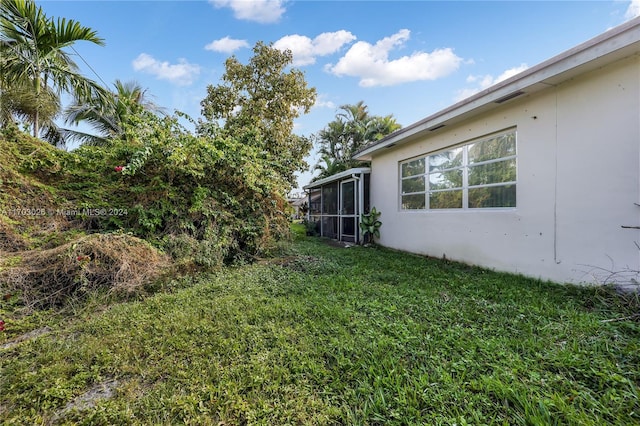 view of yard with a sunroom