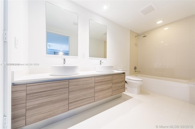 full bathroom with toilet, tile patterned flooring, vanity, and tiled shower / bath