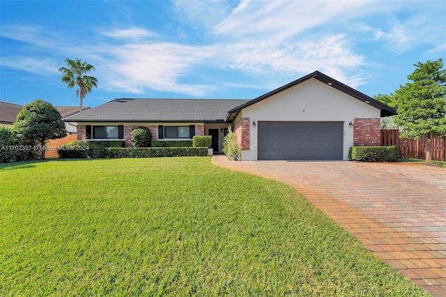 single story home featuring a garage and a front lawn