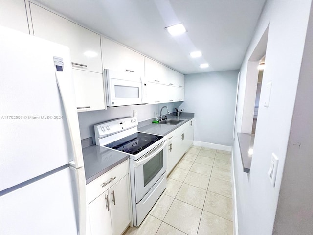 kitchen featuring white cabinets, light tile patterned floors, white appliances, and sink