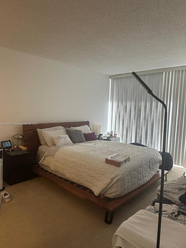 bedroom featuring carpet floors and a textured ceiling