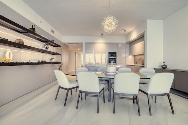 dining area with sink and a chandelier