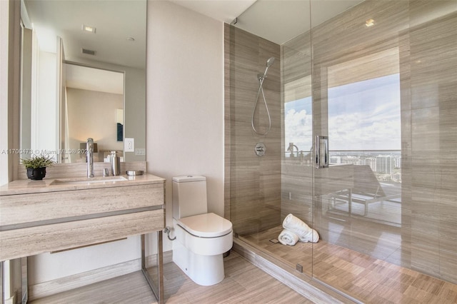 bathroom featuring hardwood / wood-style floors, vanity, toilet, and an enclosed shower