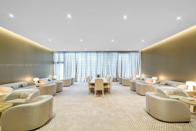 carpeted living room featuring a wall of windows