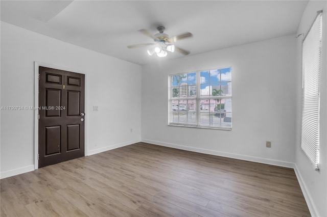 unfurnished room with light hardwood / wood-style flooring and ceiling fan