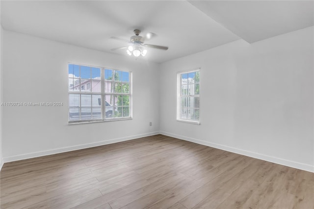 unfurnished room with ceiling fan and light wood-type flooring