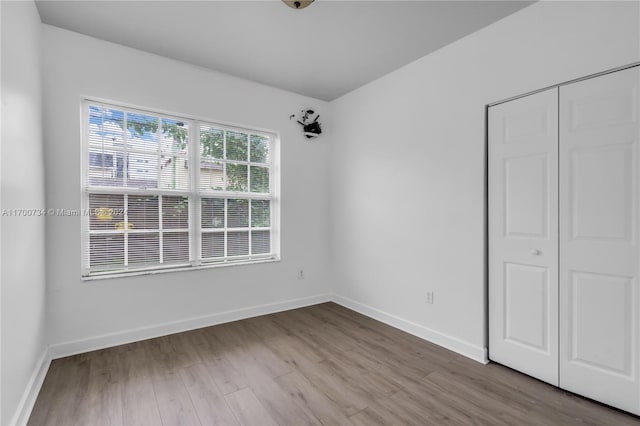 unfurnished bedroom featuring a closet and light hardwood / wood-style floors