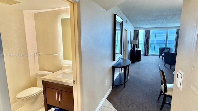 hallway with sink and a wall of windows