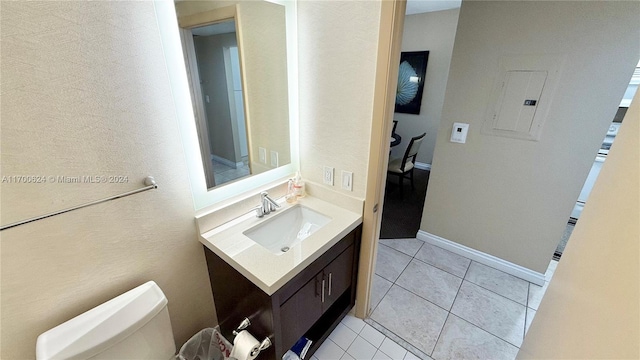 bathroom featuring tile patterned floors, electric panel, vanity, and toilet