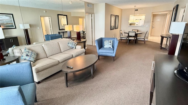 carpeted living room featuring a textured ceiling