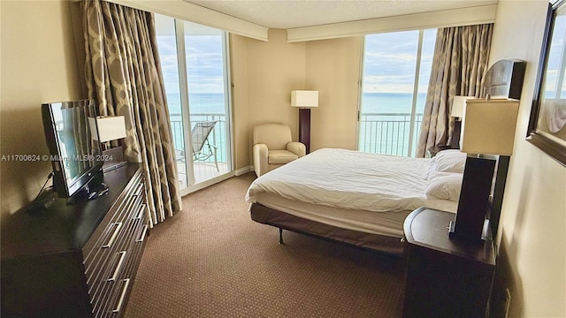 carpeted bedroom with beamed ceiling, access to outside, a water view, and multiple windows