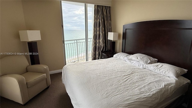 bedroom featuring a water view and access to outside