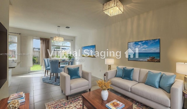 tiled living room featuring a notable chandelier