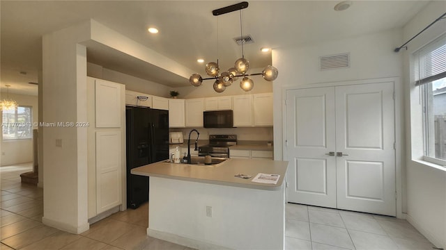 kitchen featuring sink, an inviting chandelier, a kitchen island with sink, and black appliances