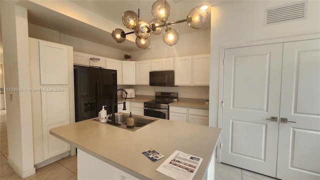 kitchen with sink, white cabinets, black appliances, and light tile patterned floors